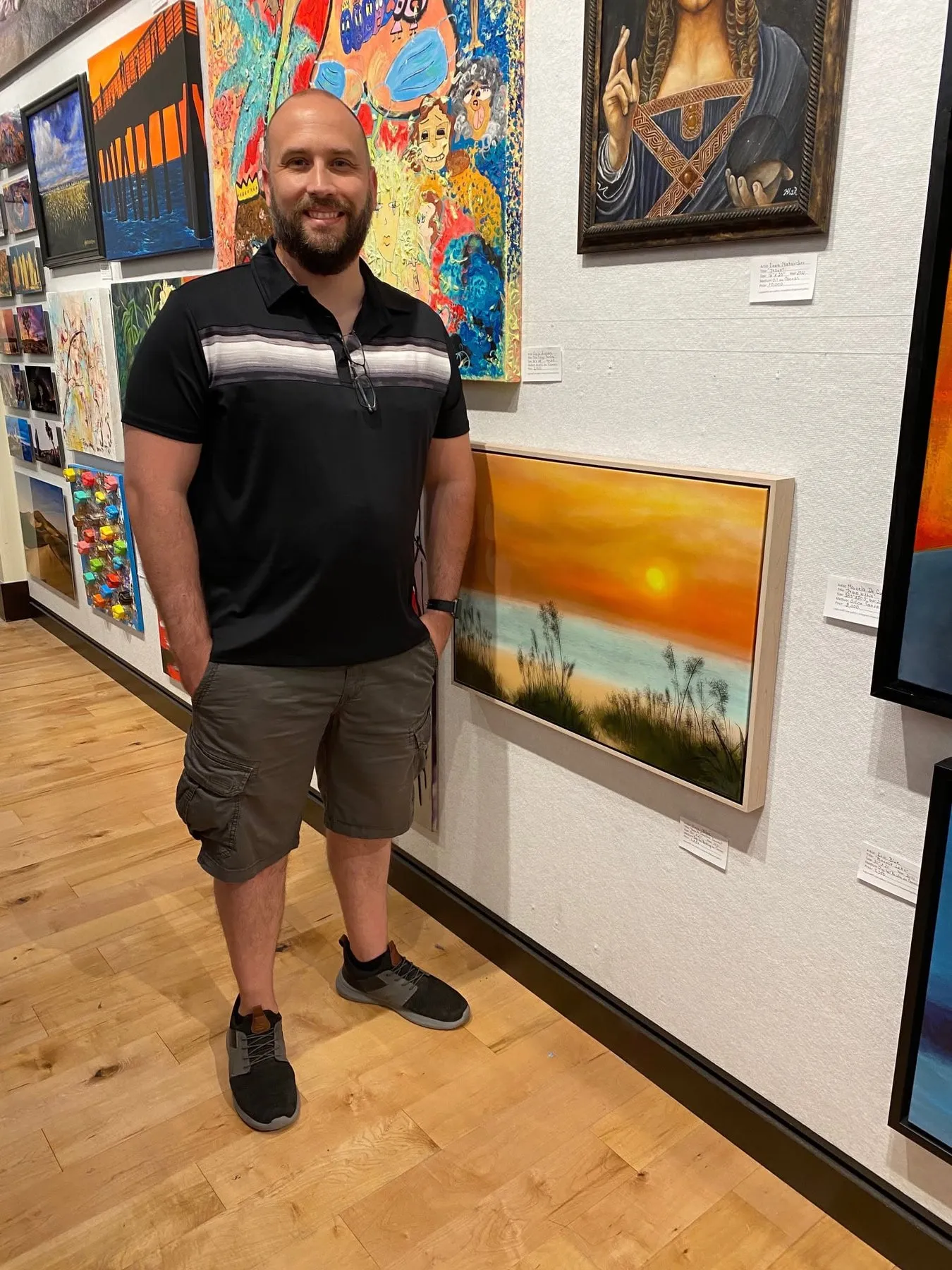 Eric Blue beside North Carolina Sunset at the Laguna Art Gallery reception